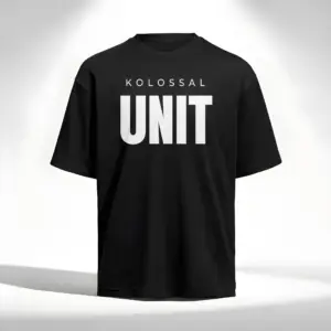Black oversized t-shirt with bold “KOLOSSAL UNIT” print on the front, minimalist design, premium fitness streetwear.