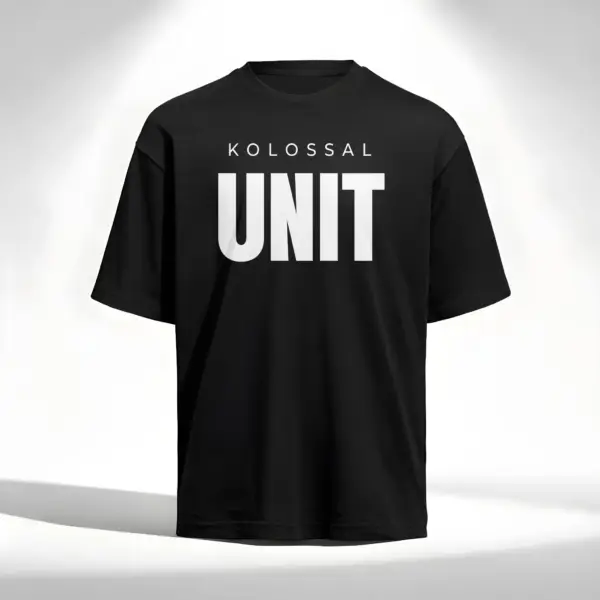 Black oversized t-shirt with bold “KOLOSSAL UNIT” print on the front, minimalist design, premium fitness streetwear.