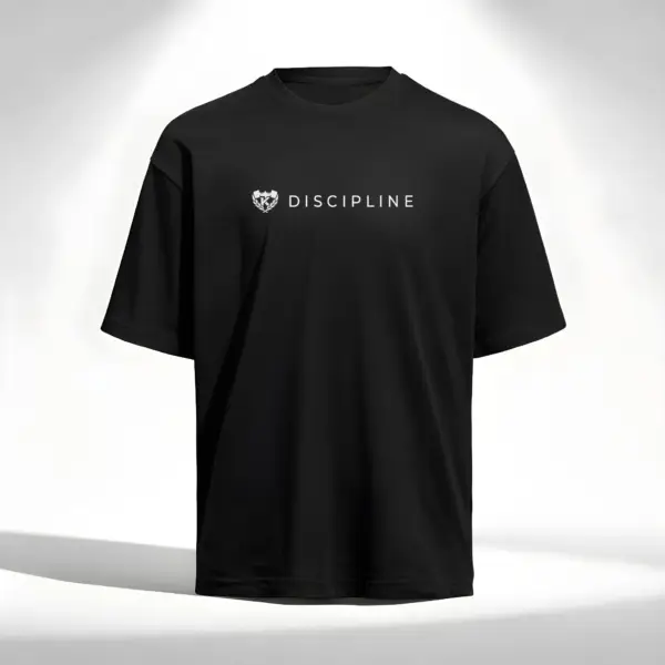 Black Kolossal Discipline loose fit gym t-shirt with minimalist white Discipline chest print on a clean light studio background. Premium oversized athletic shirt designed for hybrid training, comfort and minimalist streetwear aesthetics.