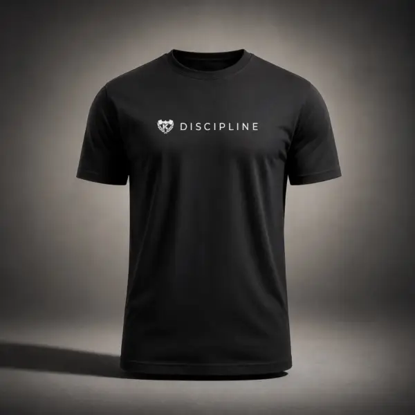 Black Kolossal Discipline regular fit gym t-shirt with minimalist white Discipline chest print photographed in a cinematic dark studio environment. Premium athletic performance shirt designed for hybrid training and everyday wear.