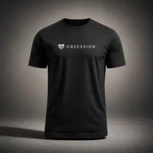 Black Kolossal Obsession regular fit gym t-shirt with minimalist white Obsession chest print photographed in a cinematic dark studio environment. Premium athletic performance shirt designed for hybrid training and everyday wear.