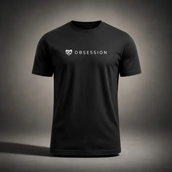 Black Kolossal Obsession regular fit gym t-shirt with minimalist white Obsession chest print photographed in a cinematic dark studio environment. Premium athletic performance shirt designed for hybrid training and everyday wear.