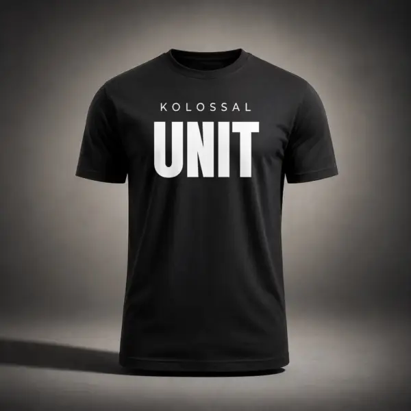 Black Kolossal Unit regular fit gym t-shirt with bold white UNIT typography on the chest, photographed in a cinematic dark studio environment. Premium athletic performance shirt designed for hybrid training and minimalist streetwear aesthetics.