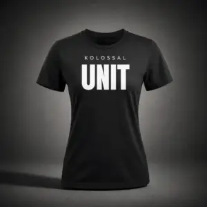 Front view of the Kolossal Unit Regular Women's T-Shirt featuring the bold KOLOSSAL UNIT graphic on premium black 180 GSM fabric.