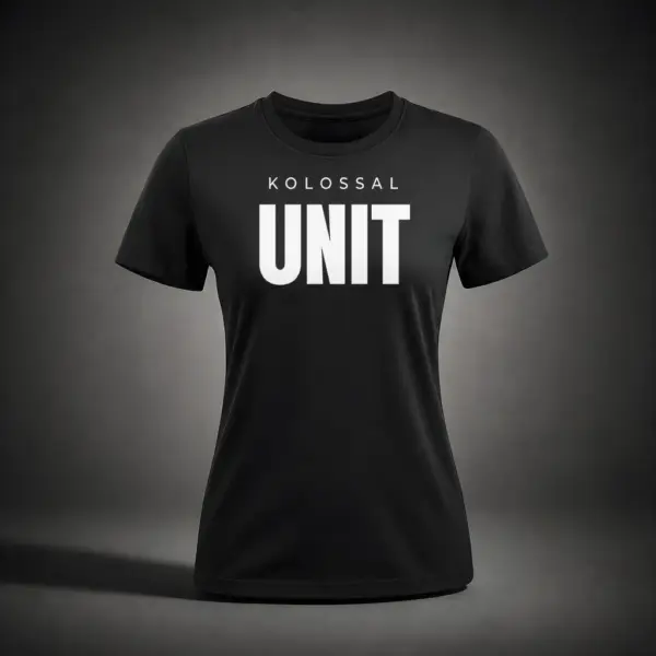 Front view of the Kolossal Unit Regular Women's T-Shirt featuring the bold KOLOSSAL UNIT graphic on premium black 180 GSM fabric.