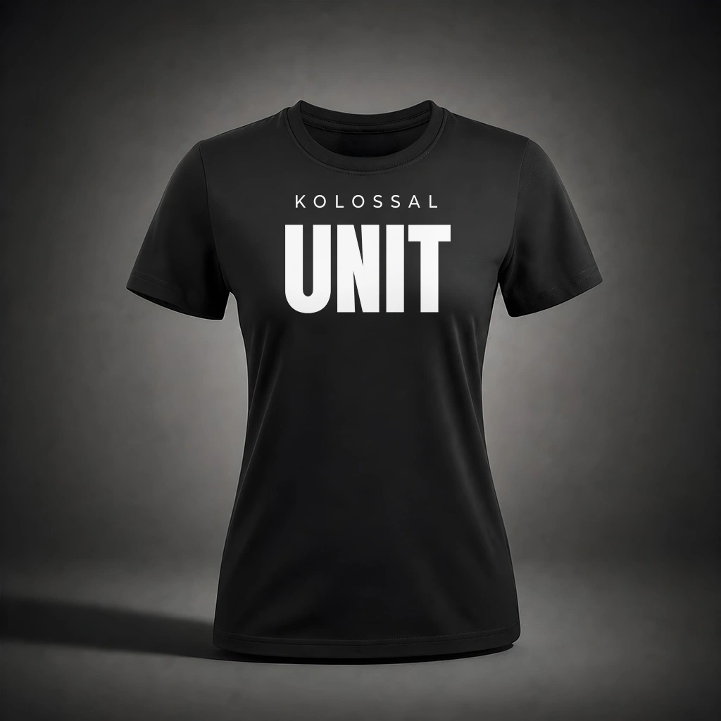 Front view of the Kolossal Unit Regular Women's T-Shirt featuring the bold KOLOSSAL UNIT graphic on premium black 180 GSM fabric.