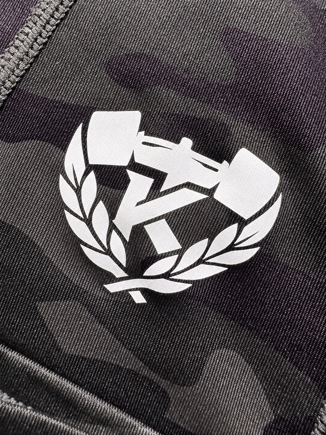 Close-up of the Kolossal logo printed on the Tactical Compression Leggings.
